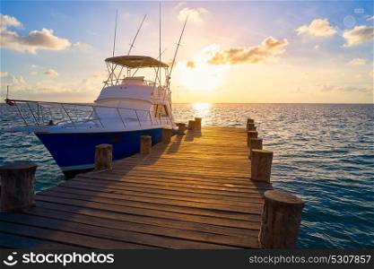 Riviera Maya sunrise fishing boat at beach pier in Mayan Mexico