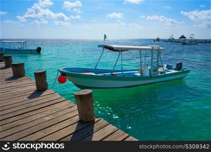 Riviera Maya wood pier and boats in Mayan Mexico