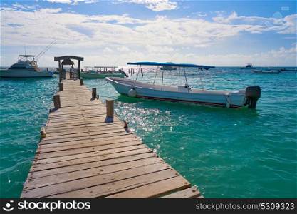 Riviera Maya wood pier with Caribbean boats in Mexico