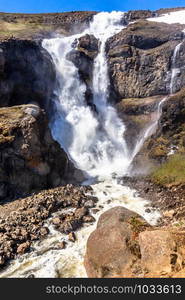 Rjukandi waterfall powerful streams falling from mountains, Egilsstadir, Eastern Iceland