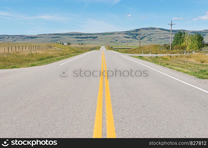 Road across the plains near Fort MacLeod, Alberta, Canada