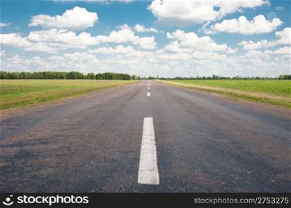 Road. An automobile line and the bright dark blue sky