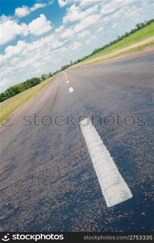 Road. An automobile line and the bright dark blue sky