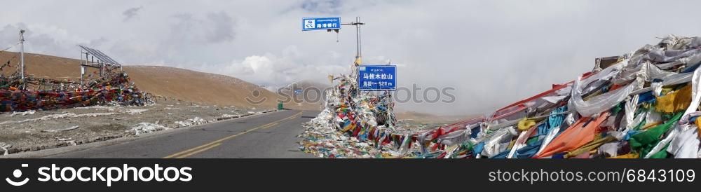Road and flags on the Ma Yu La Pass in Tibet, China