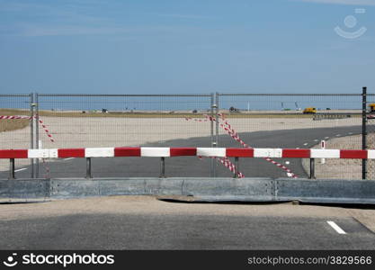 road blocked by metal fence and red white block