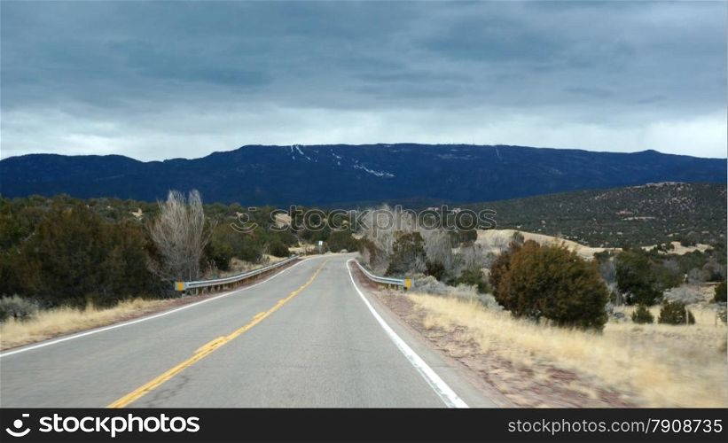 Road in Arizona states with cloudy sky . USA road