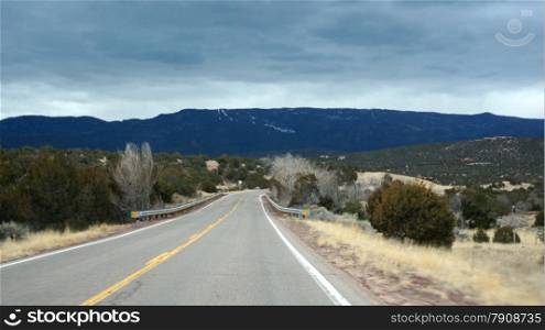 Road in Arizona states with cloudy sky . USA road