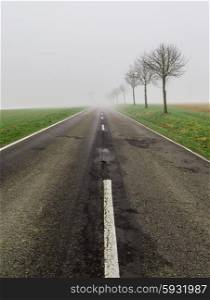 Road in fog leads to nothing. Road in fog leads to nothing.