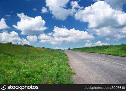 Road in green meadow. Nature composition.