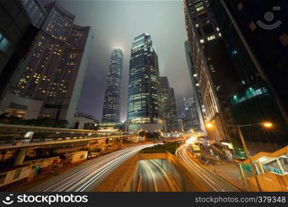 Road in Hong Kong Downtown. Financial district and business centers in smart city and technology concept. skyscraper and high-rise office buildings at night. International Finance Center