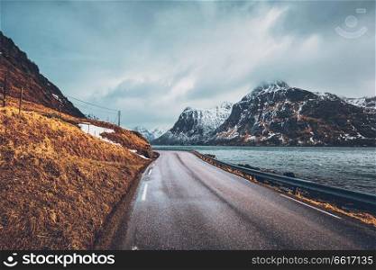Road in Norwegian fjord. Lofoten islands, Norway. Road in Norway along the fjord