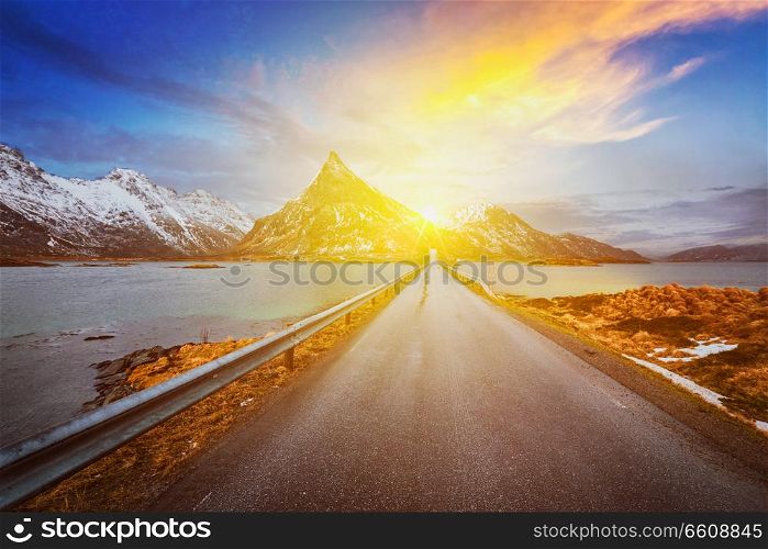 Road in Norwegian fjord on sunset. Lofoten islands, Norway. Road in Norway in fjord on sunset