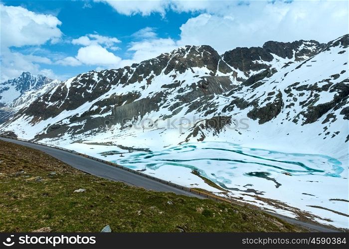 Road in summer Alps mountain and frozen lake (Austria).