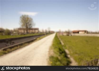 Road in the fields, blurred background, horizontal image
