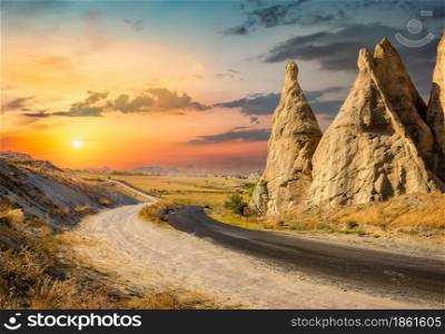 Road in the mountains of Cappadocia at sunset. Mountains landscape in Turkey