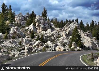 road in the mountains with rocks and trees