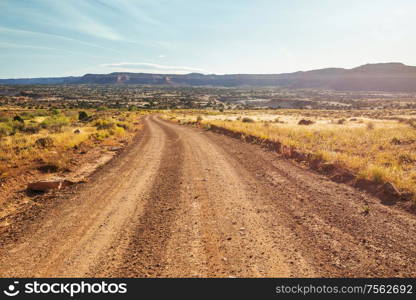 Road in the prairie country. Deserted natural travel background.