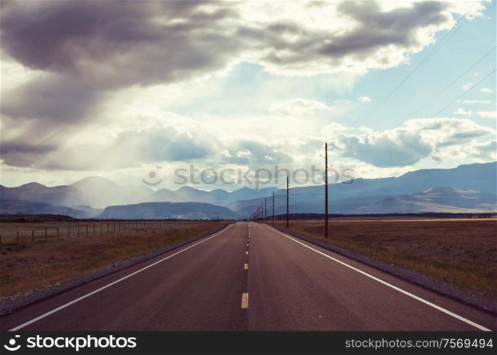 Road in the prairie country. Deserted natural travel background.