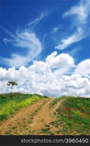 Road in village and beautiful clouds. Nature composition.
