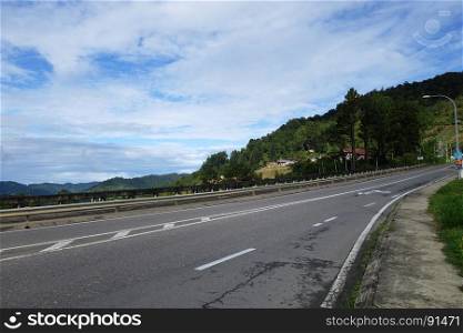 Road into hills with blue sky at Sabah,Borneo,Malaysia