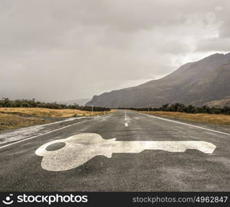 Road leading to success. Natural landscape of asphalt road and drawn key as success symbol