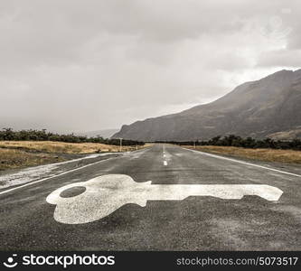 Road leading to success. Natural landscape of asphalt road and drawn key as success symbol