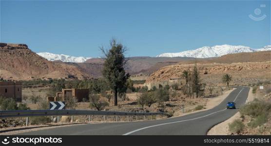 Road leading towards snowcapped mountains, Atlas Mountains, Morocco
