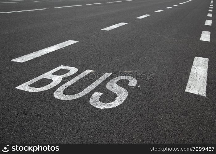 Road marking over black asphalt of carriageway