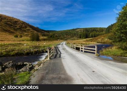 Road of the Abergwesyn Pass crossing over the River Afon Irfon. Powys, Wales, United Kingdom, Europe.