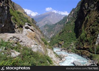 Road on the Annapurna trail and river in Nepal
