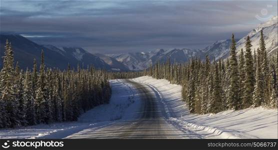 Road passing through snow covered landscape, Alaska Highway, Northern Rockies Regional Municipality, British Columbia, Canada