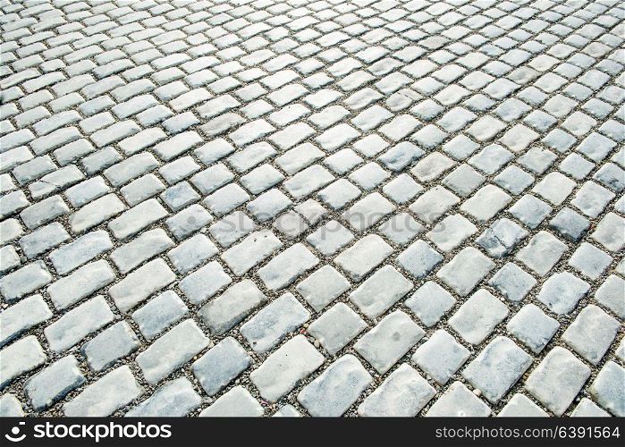 Road paved with cobble stones for your background