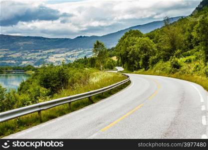 Road running through norwegian mountains. Beautiful landscape. Travel and tourism.. Road landscape in norwegian mountains