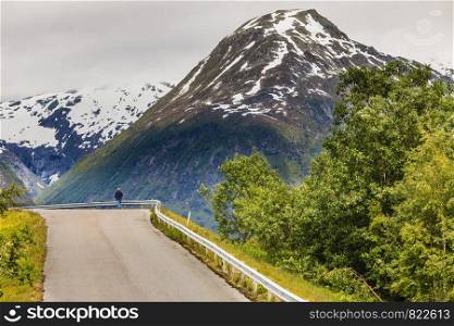 Road running through norwegian mountains. Beautiful landscape. Travel and tourism.. Road landscape in norwegian mountains