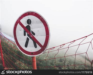 "Road sign "Don&rsquo;t walk" in the fog of clouds. Caucasus mountains"