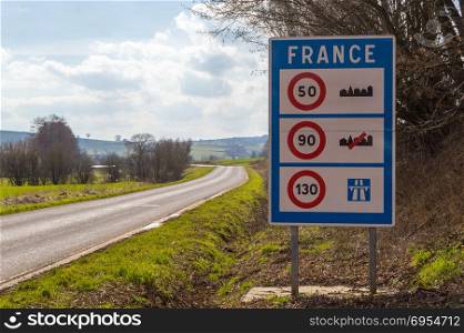 Road sign of return to the French territory . Road sign of return to the French territory with different speed limits along the roads.