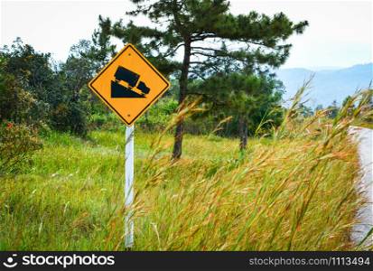 Road sign Steep Slope warning traffic and truck on hill mountain