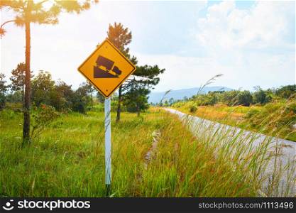 Road sign Steep Slope warning traffic and truck on hill mountain