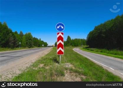 Road sign with arrows. Two different directions. Concept of choose the correct way. Right and left directional traffic signpost. Crossroad sign. Empty highway. Junction, fork, split road sign post.