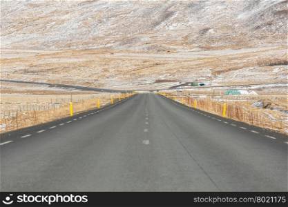 Road streching out Iceland Winter landscape snow mountain