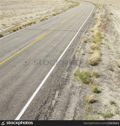 Road through barren landscape in Utah.