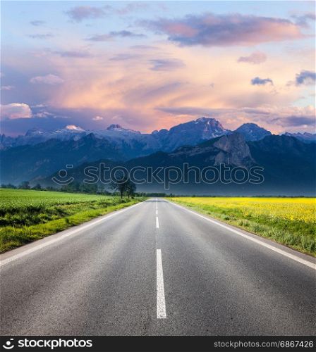 Road through countryside landscape to the mountain
