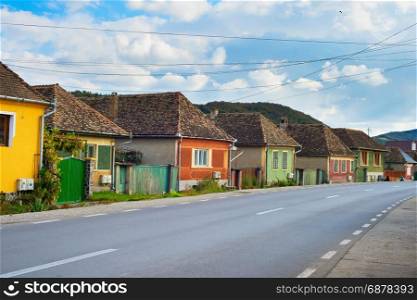 Road through typical Romanian Transylvanian village. Romania