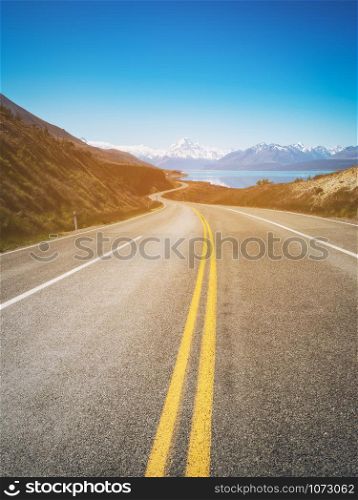 Road to Mount Cook, the highest mountain in New Zealand. A scenic highway drive along Lake Pukaki in Aoraki Mount Cook National Park, South Island of New Zealand. Shot at Highway 80 (Mt Cook Road).