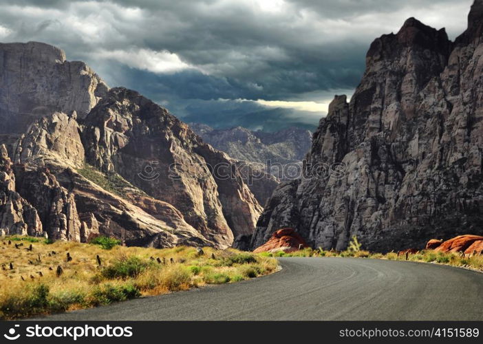 road to mountains and dramatic sky