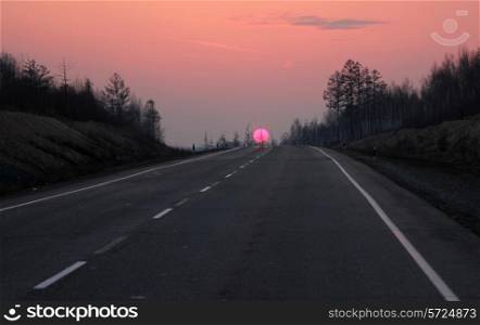 Road to Siberia in winter sunset.