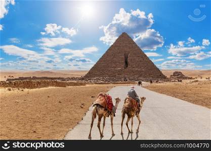 Road to the Pyramid of Menkaure and the bedouin with camels, Giza, Egypt.. Road to the Pyramid of Menkaure and the bedouin with camels, Giza, Egypt