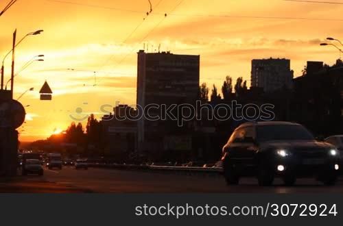 road traffic in the city at sunset