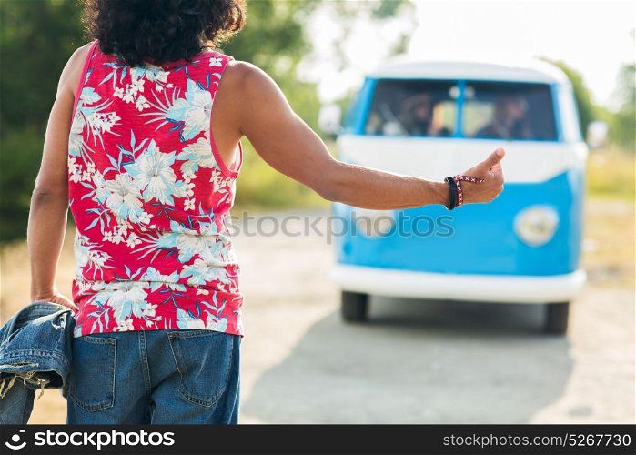 road trip, hitchhike, travel, gesture and people concept - man stopping minivan car at countryside. man hitchhiking and stopping minivan car