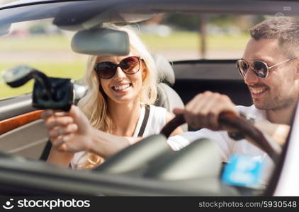 road trip, leisure, travel, technology and people concept - happy man and woman driving car and using gps navigation system